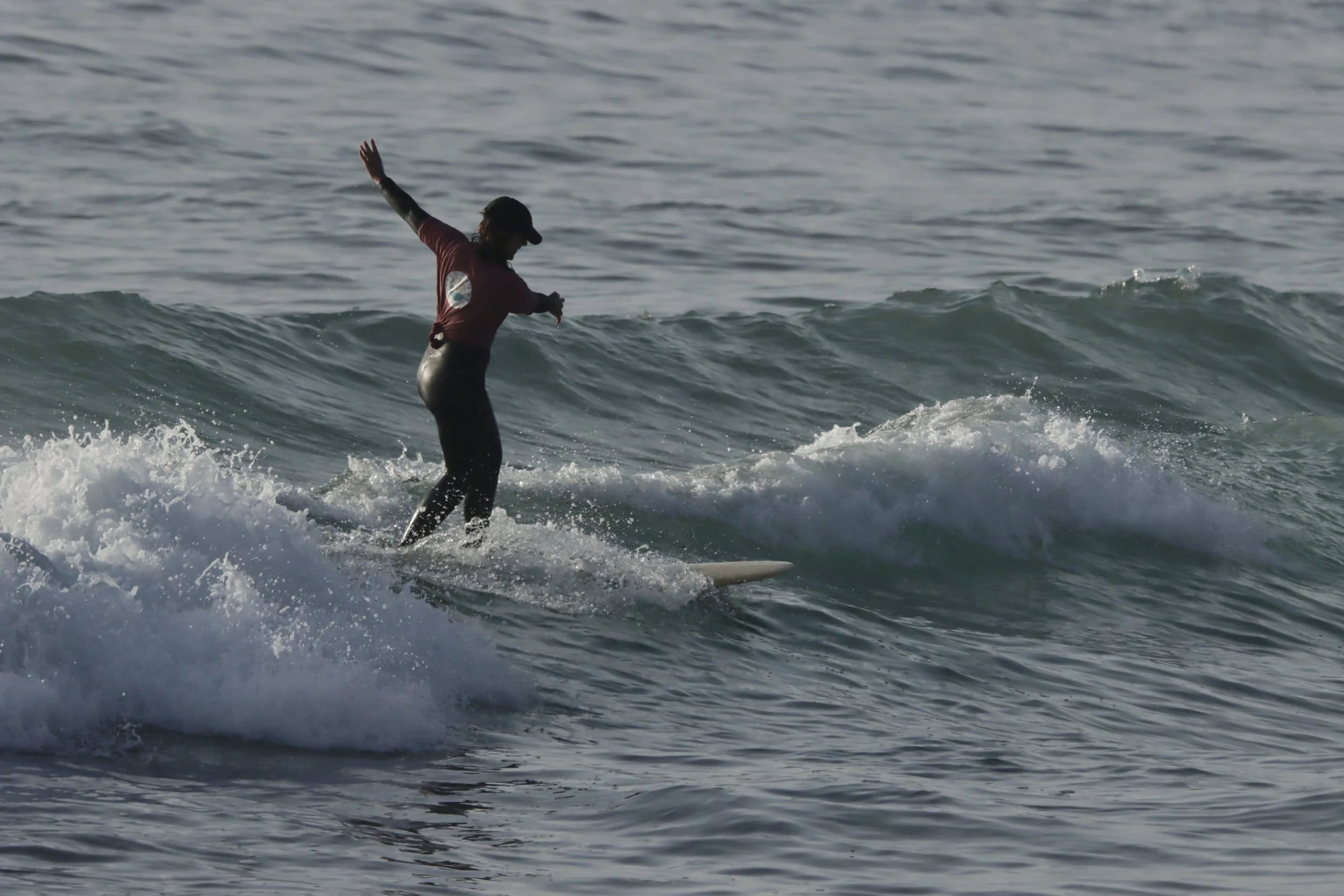 Sunset surf with a longboard at Crocros, Tamraght, Taghazout Bay, Morocco