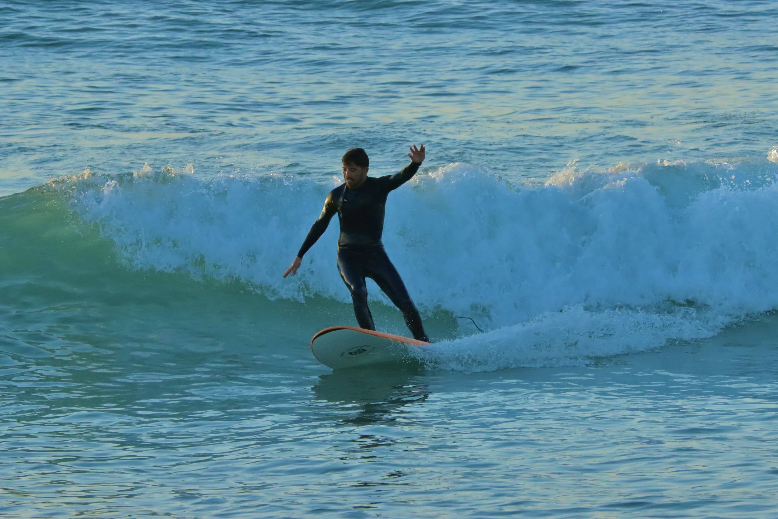 Khalid, Local Surf Maroc instructor surfing sunset at Crocros, Tamraght, Morocco.