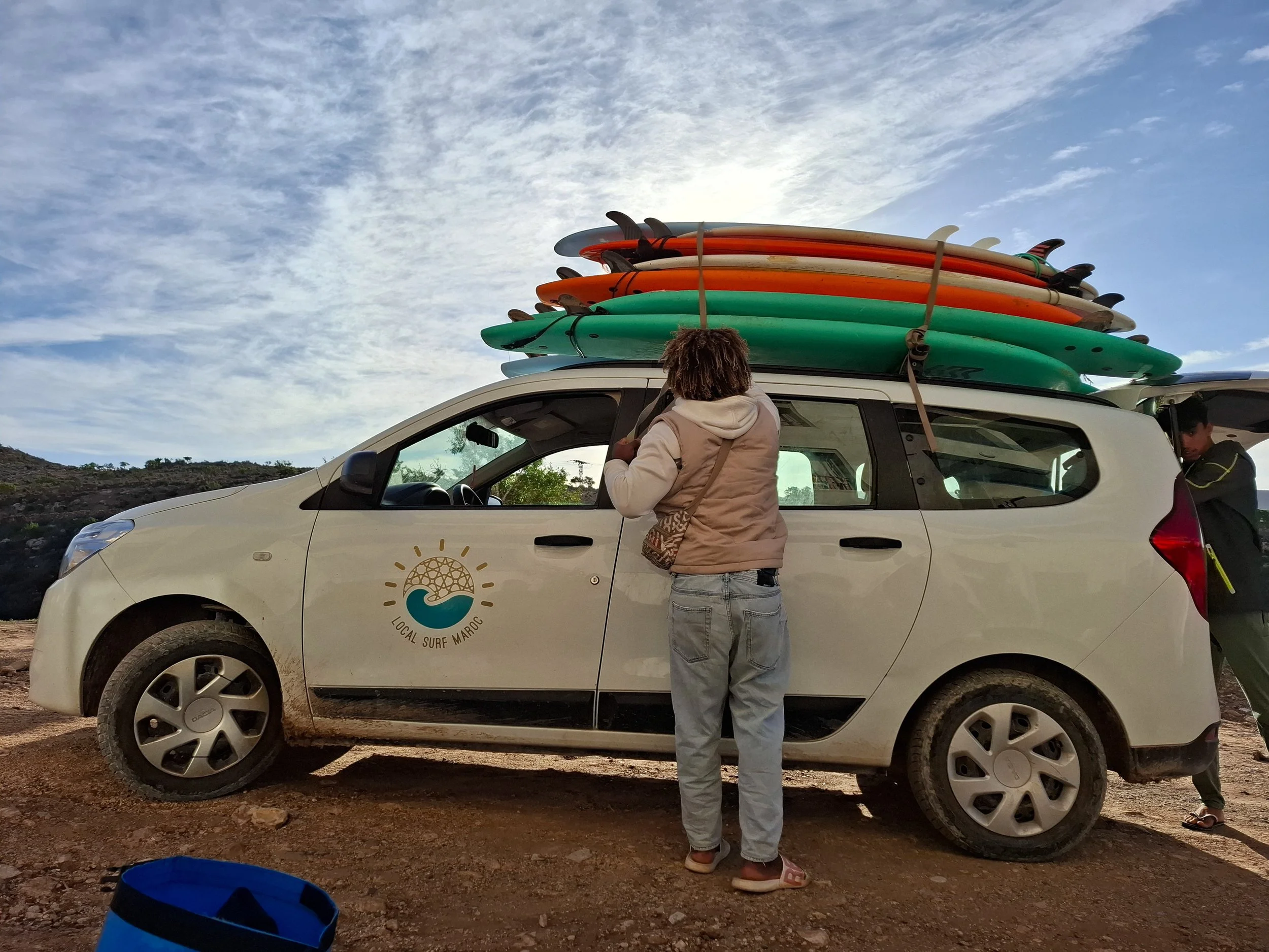 Local Surf Maroc instructor packing the surf car with surf boards, Tamraght, Morocco.