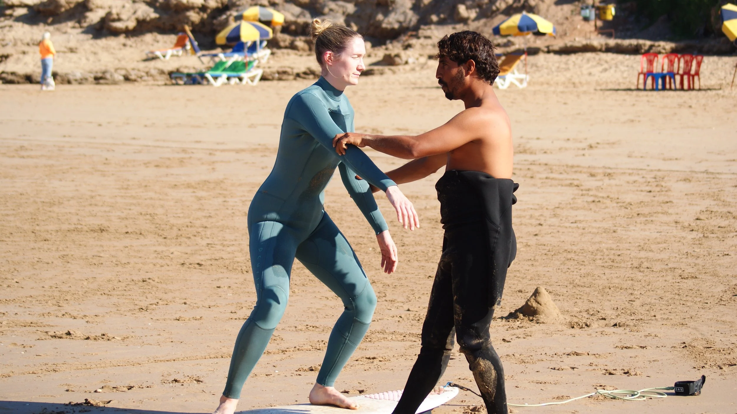 Rachid, Head Coach at Local Surf Maroc correcting the turn technique on the beach, Tamraght, Morocco.