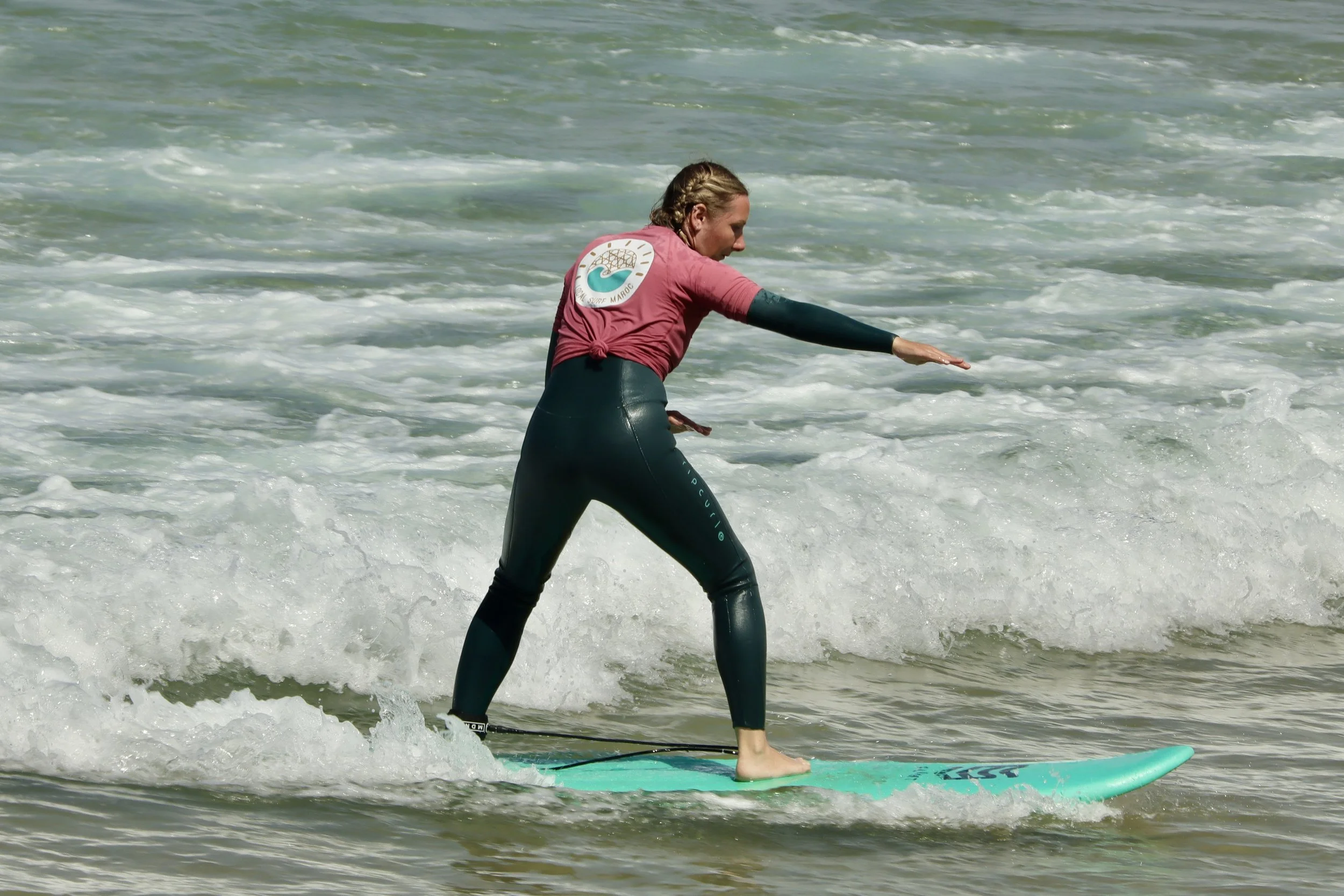 Beginner surfer practicing takeoffs independently in whitewash at Crocros, Tamraght, Morocco
