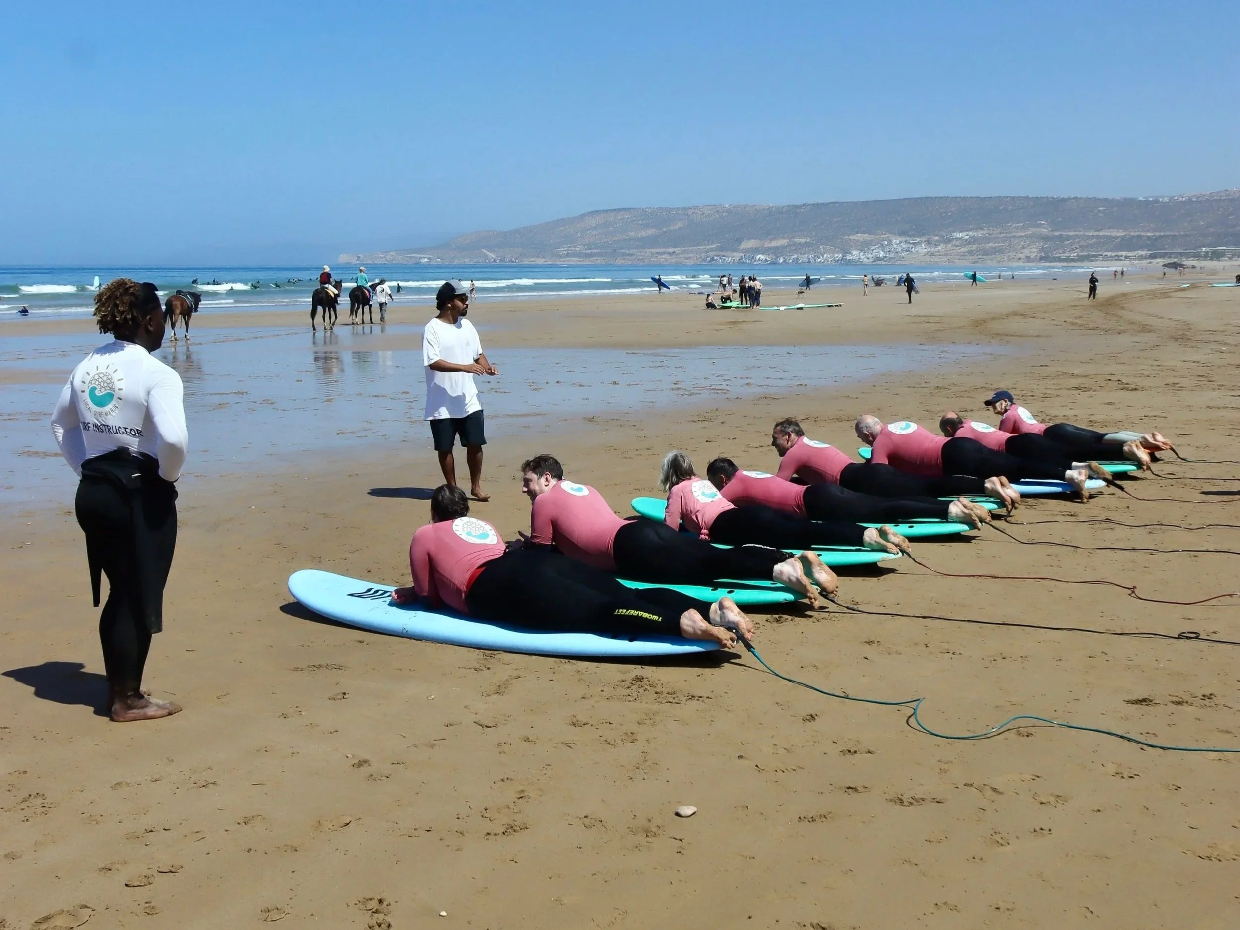 Beginner group surf coaching lesson at Crocros, Tamraght, Morocco with small instructor to student ratio.