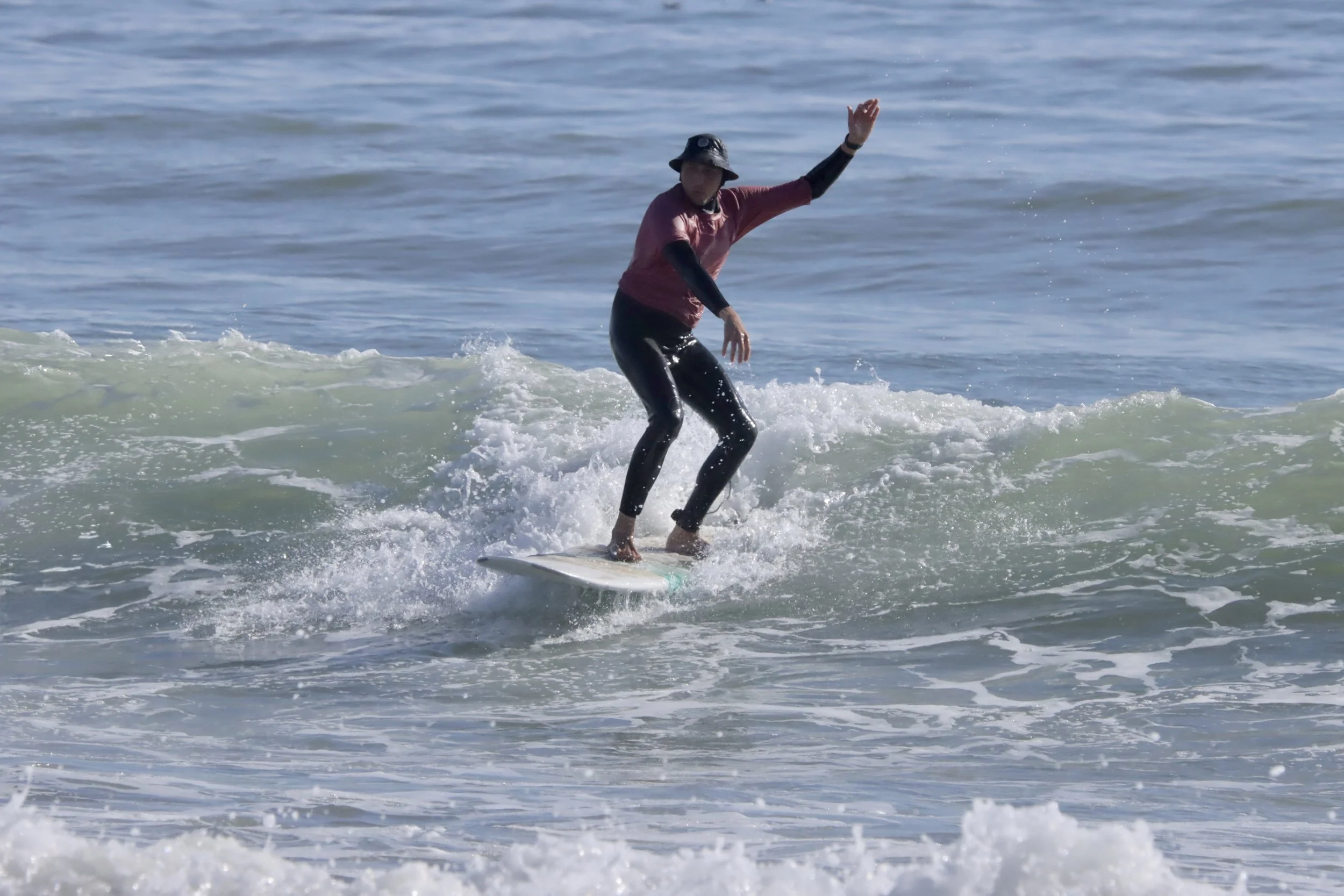 Intermediate surfer on a challenging wave at Banana Point, Aourir, Morocco.