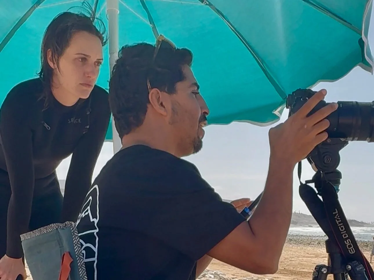 Advanced Intermediate surfer reviewing her surf footage with Rachid at Banana Point, Aourir, Morocco.