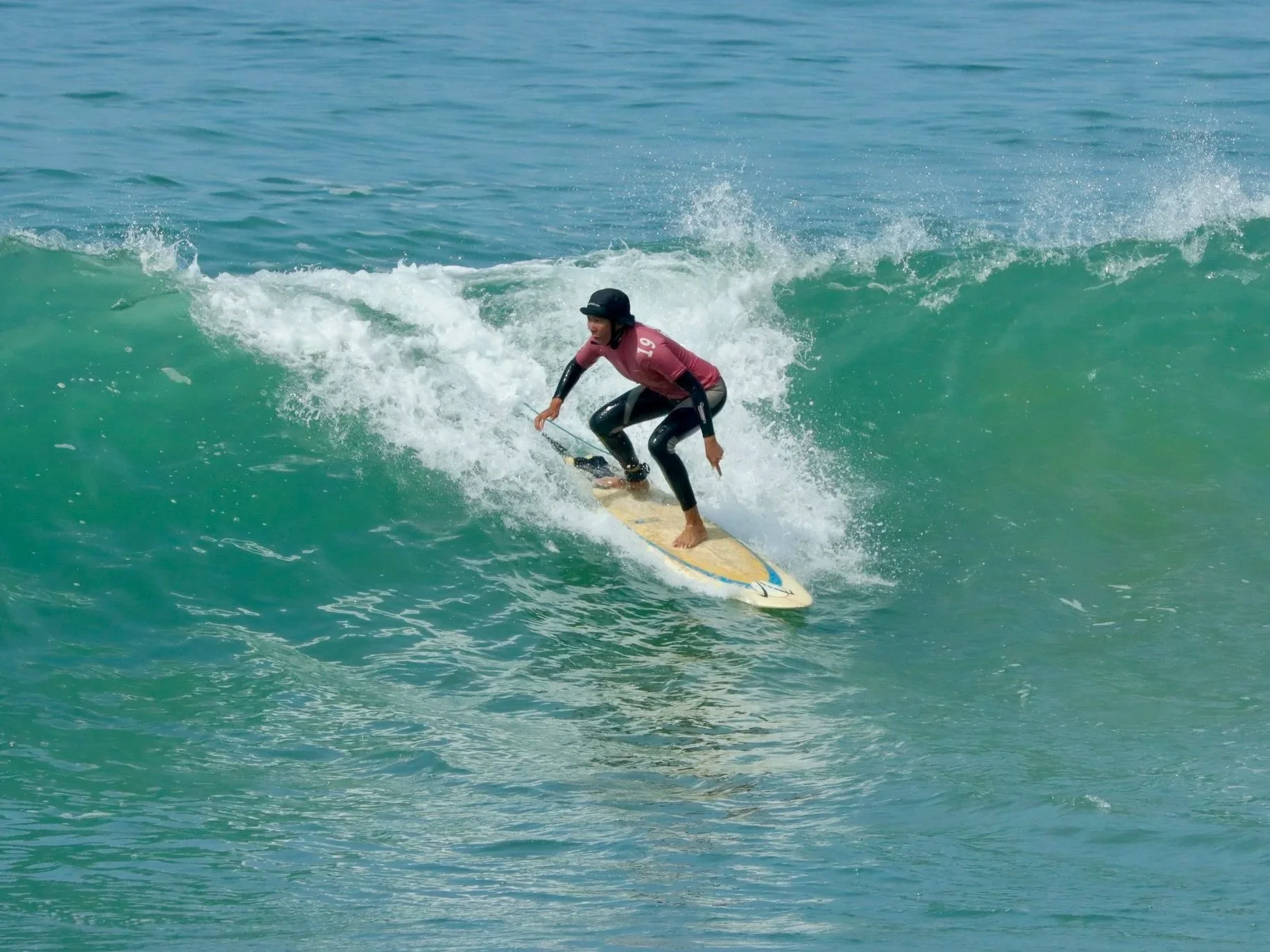Catching a big wave before executing a bottom turn.
