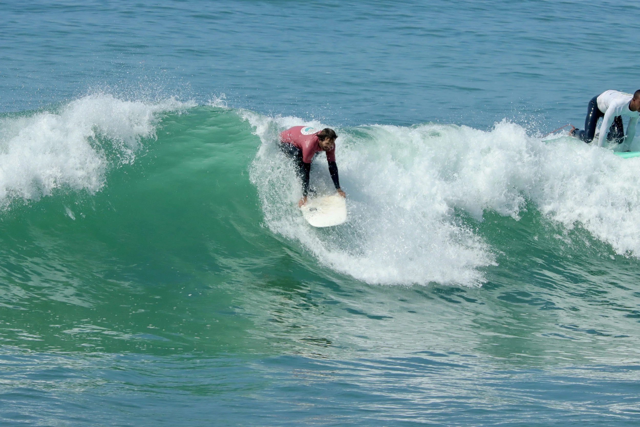 Intermediate surfer with Local Surf Maroc struggling with a takeoff in Morcco.