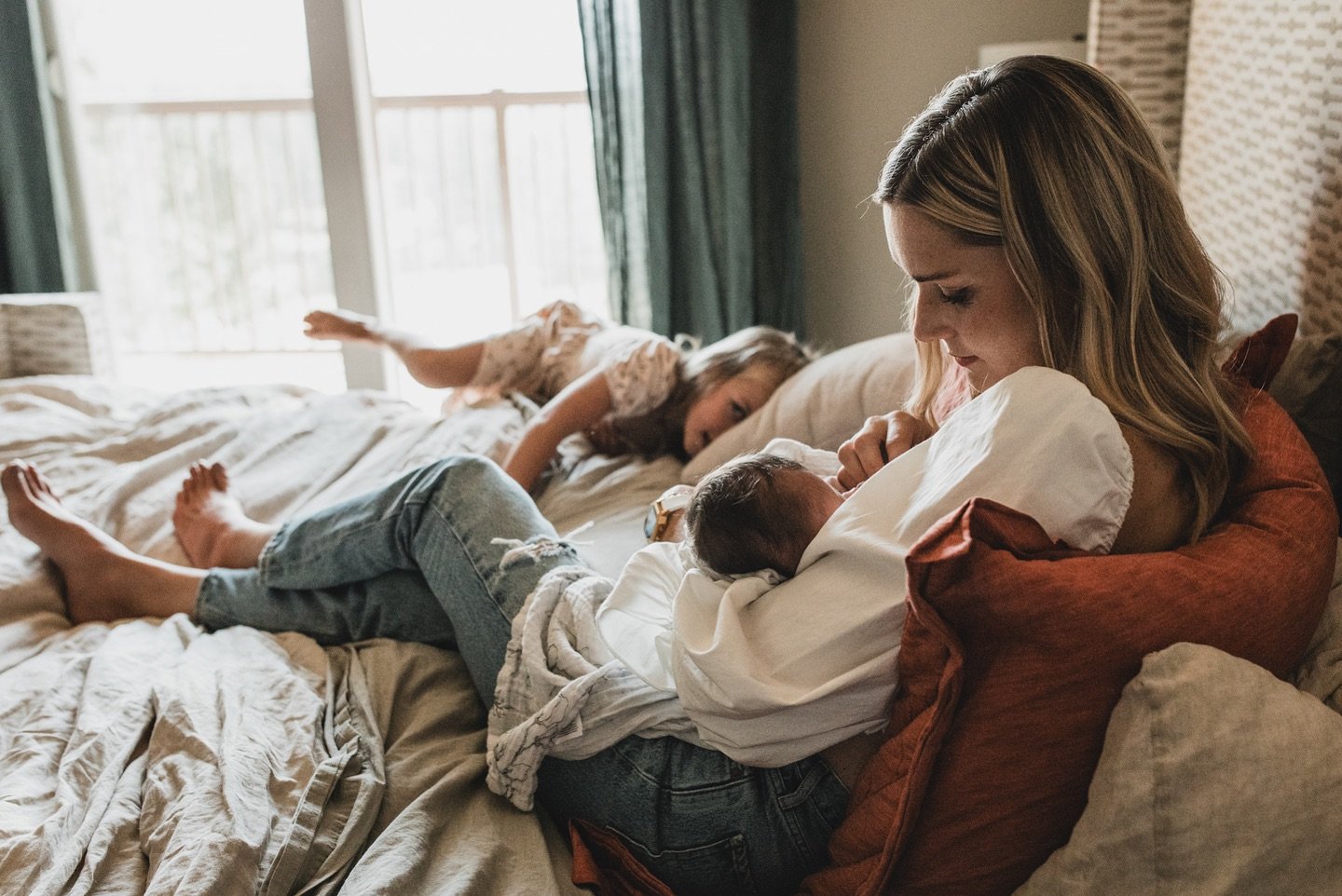 This will forever be one of my favorite photos.

Not because it is perfect, but because it feels right.

A mother nursing her baby while another child plays in the room.

The backlighting is creating a glow.

The warm and cool tones are balanced.

It