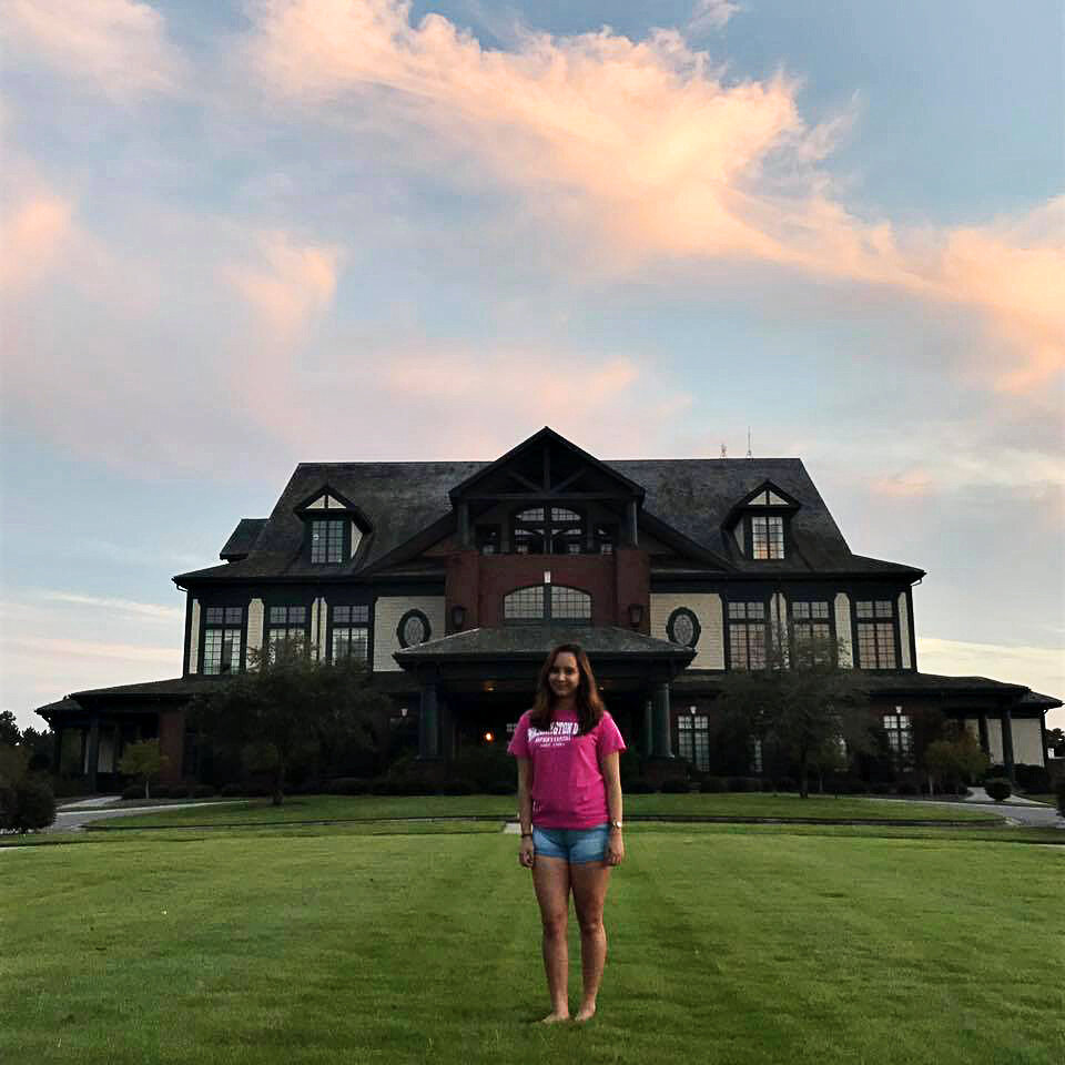 Camille in front of the River Landing Clubhouse last summer.