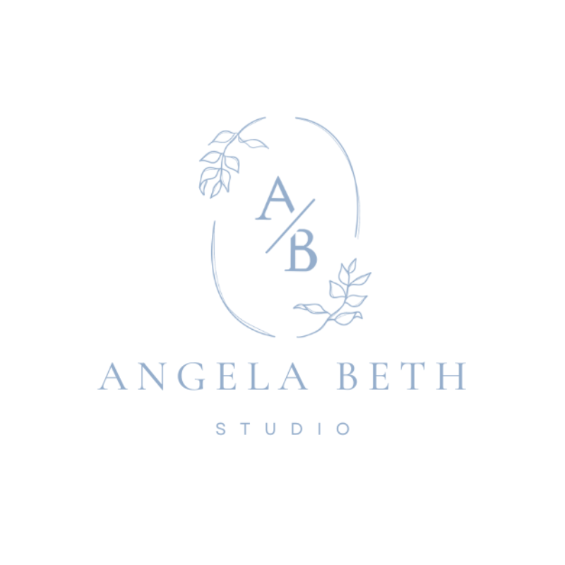 Logo for Angela Beth Studio featuring an oval outline, with leaves on either side, and the letters A/B inside the oval
