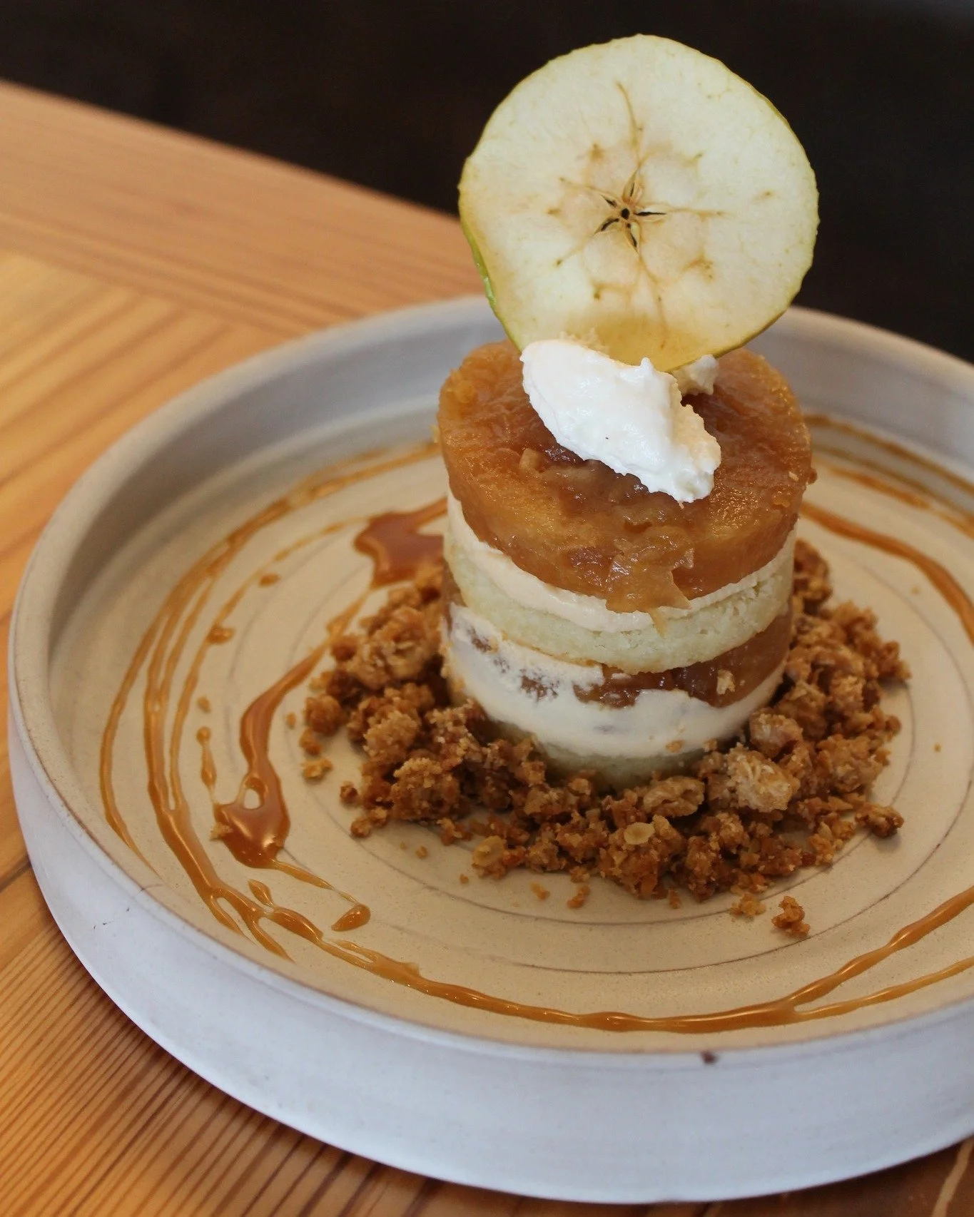Mela e Ricotta: Apple and ricotta. A classic pairing in Italian baking, presented with an Aventine twist.

Our version layers ricotta cake with salted caramel mousse and compressed apple, then finishes it with streusel, caramel sauce, and ricotta lem