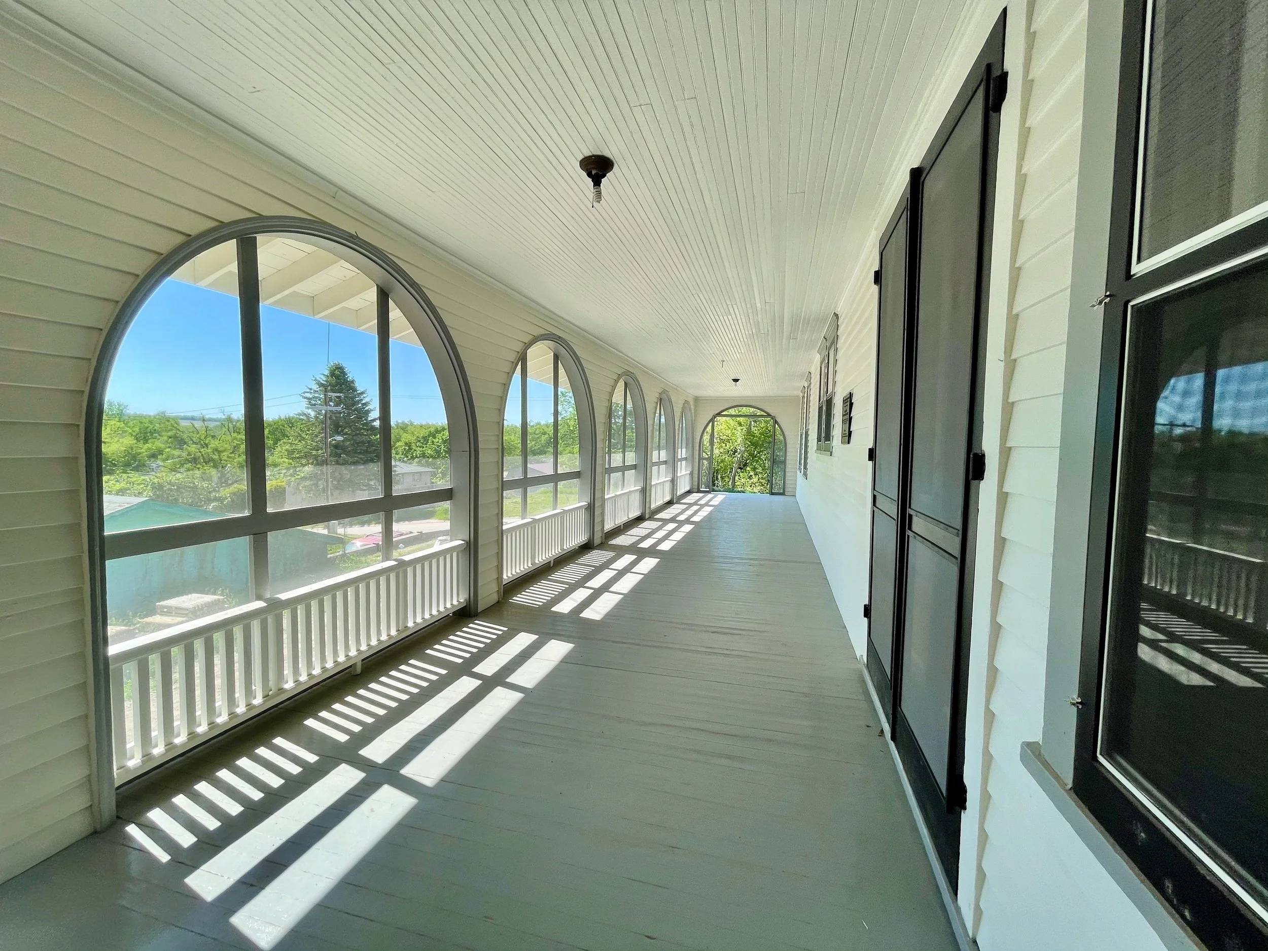 A corridor of the Dr. Susan La Flesche Picotte Center with large windows showing the landscape