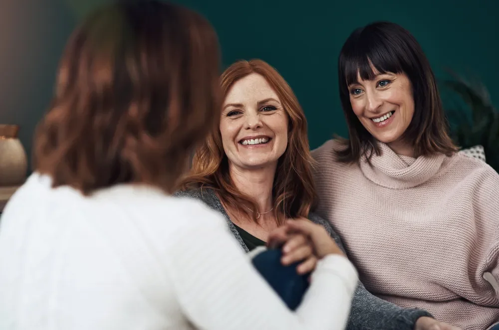 Lesbian couple sitting together during a relationship therapy session.
