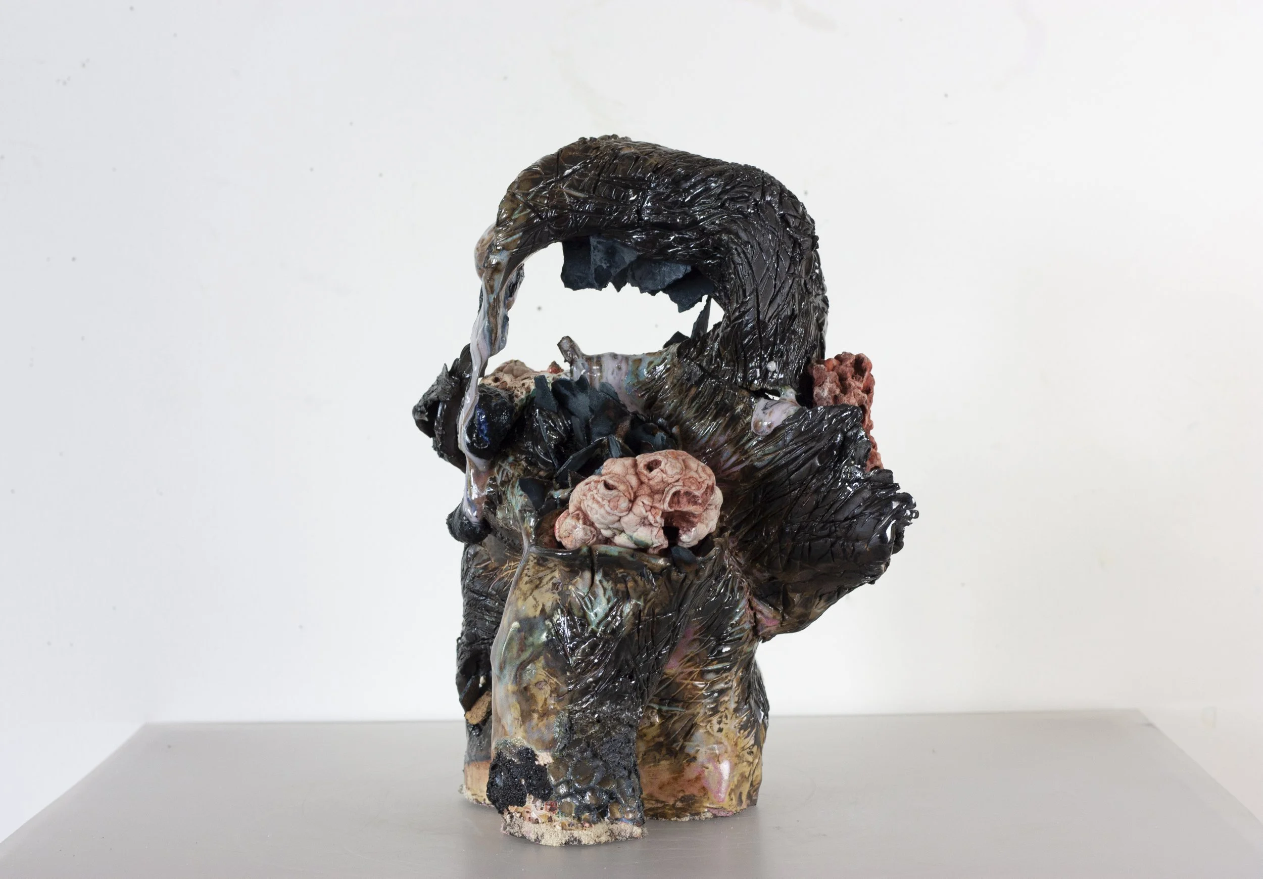 "Scorpion Mother," 2023. Serrated black stoneware, underglaze, crushed steel glaze, melted steel chips, Huzzah Valley found rocks, studio detritus, glaze.
