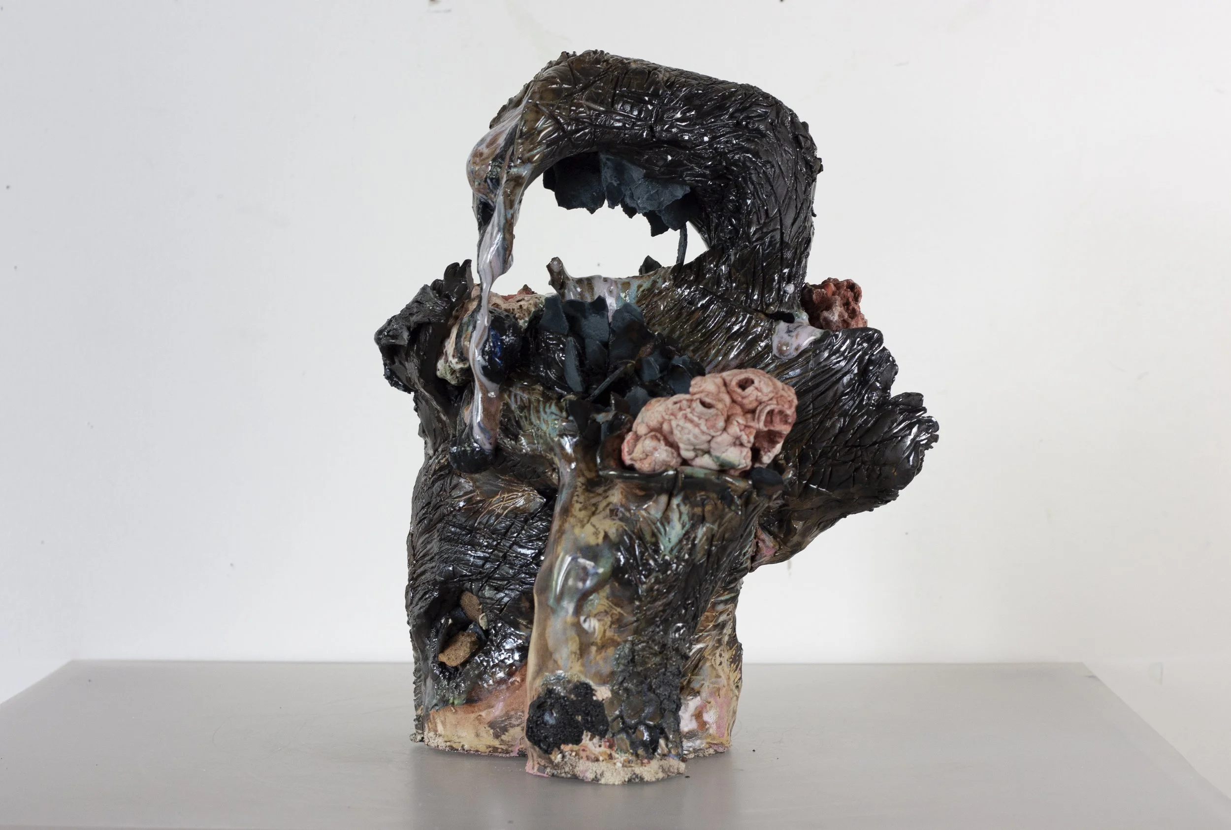 "Scorpion Mother," 2023. Serrated black stoneware, underglaze, crushed steel glaze, melted steel chips, Huzzah Valley found rocks, studio detritus, glaze.