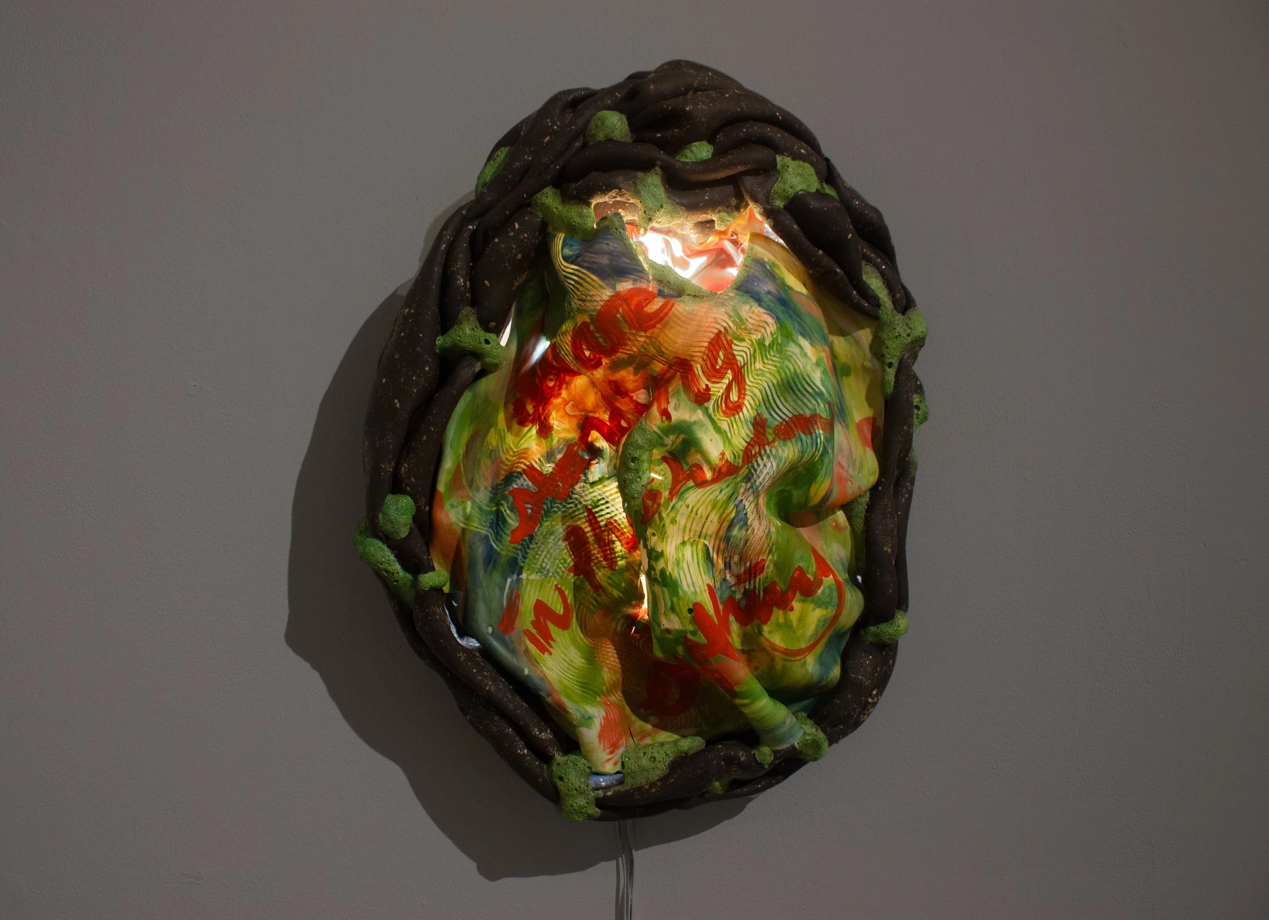 "You are standing in the shadow of everything," 2025. Translucent porcelain, stoneware, glaze, lighting. 18 x 16 x 5 inches. 