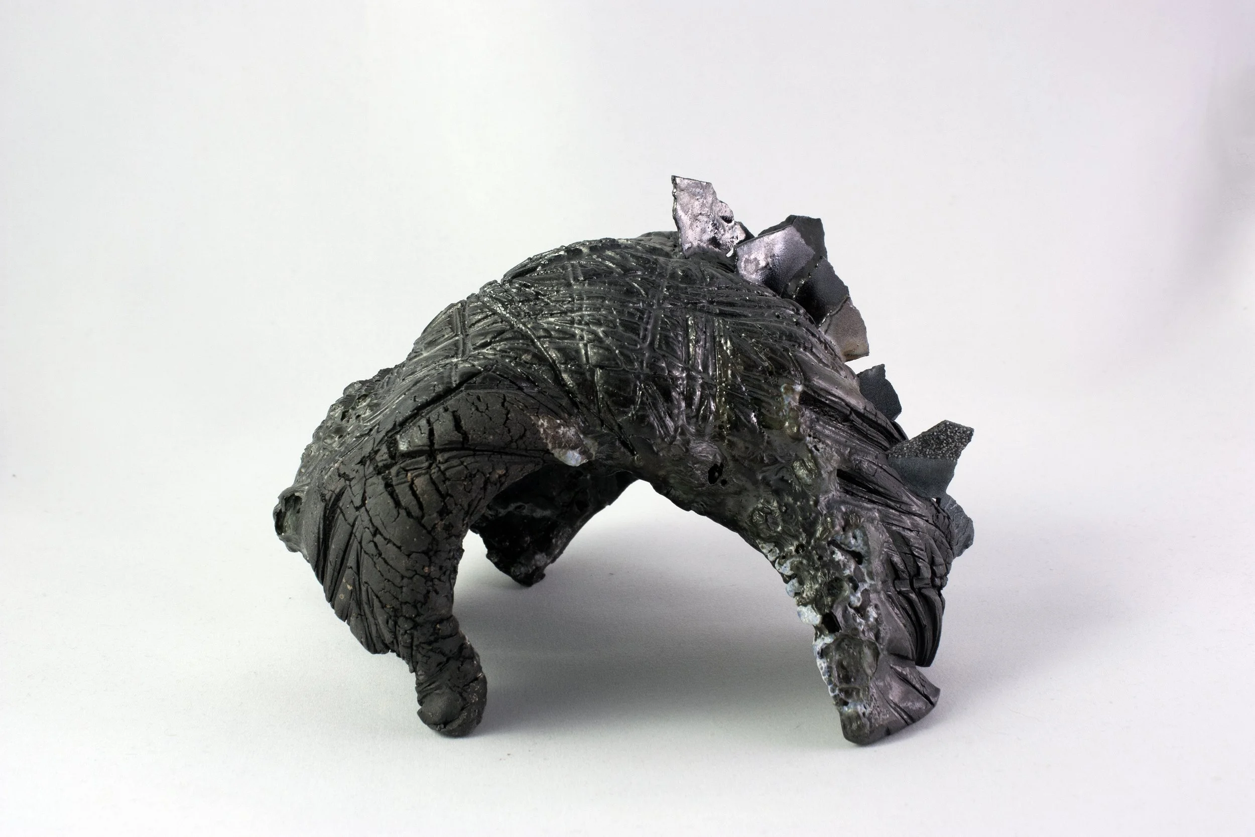 Cavern, 2023. Black stoneware, steel shards, glaze.
