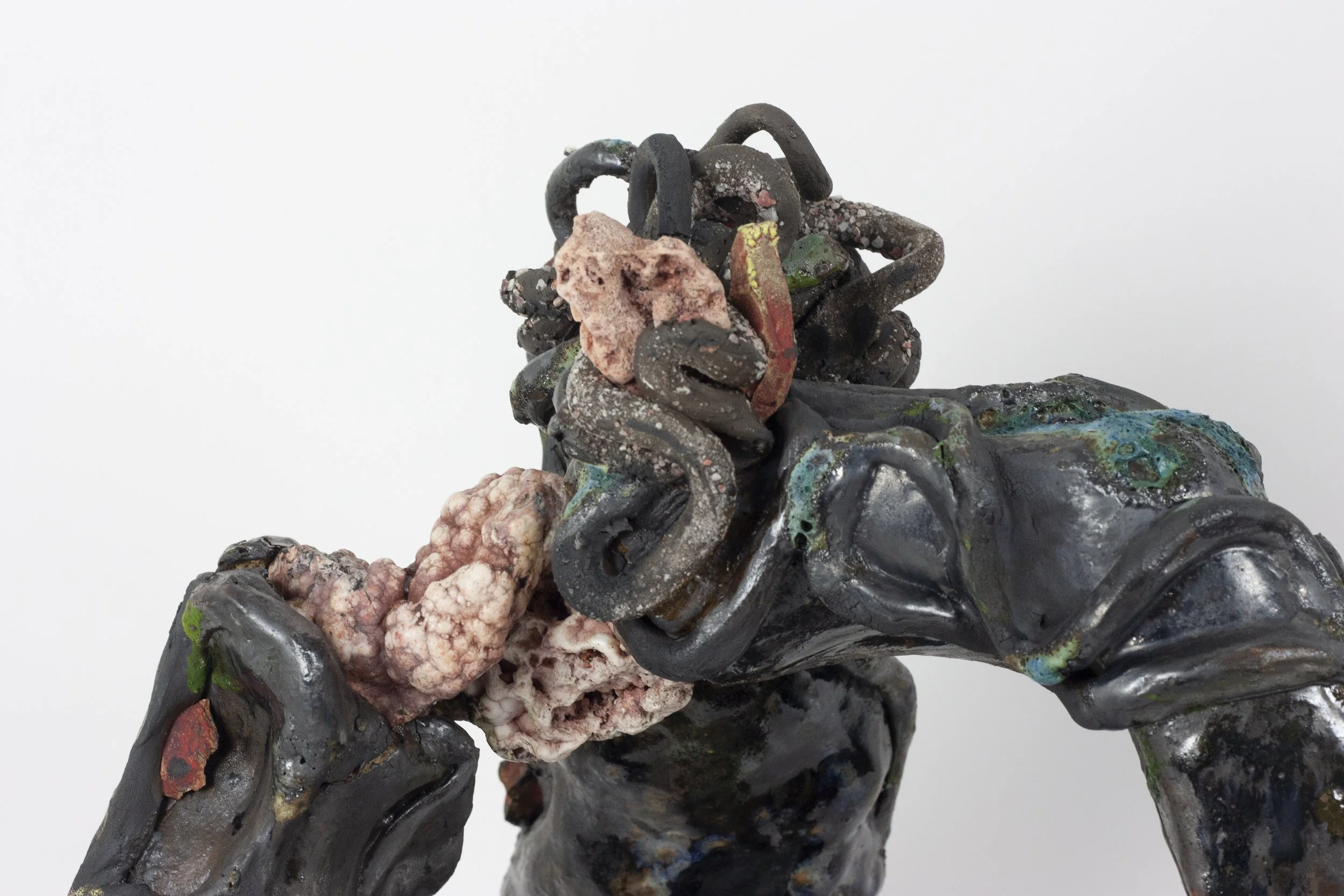 "Age undoes itself/and plays the Ouroboros" 2023. Black clay, shards of exploded bisque soaked in red pigment, Ozark rocks, Houston sand, gravel, glaze. 23 x 17 x 11 inches.