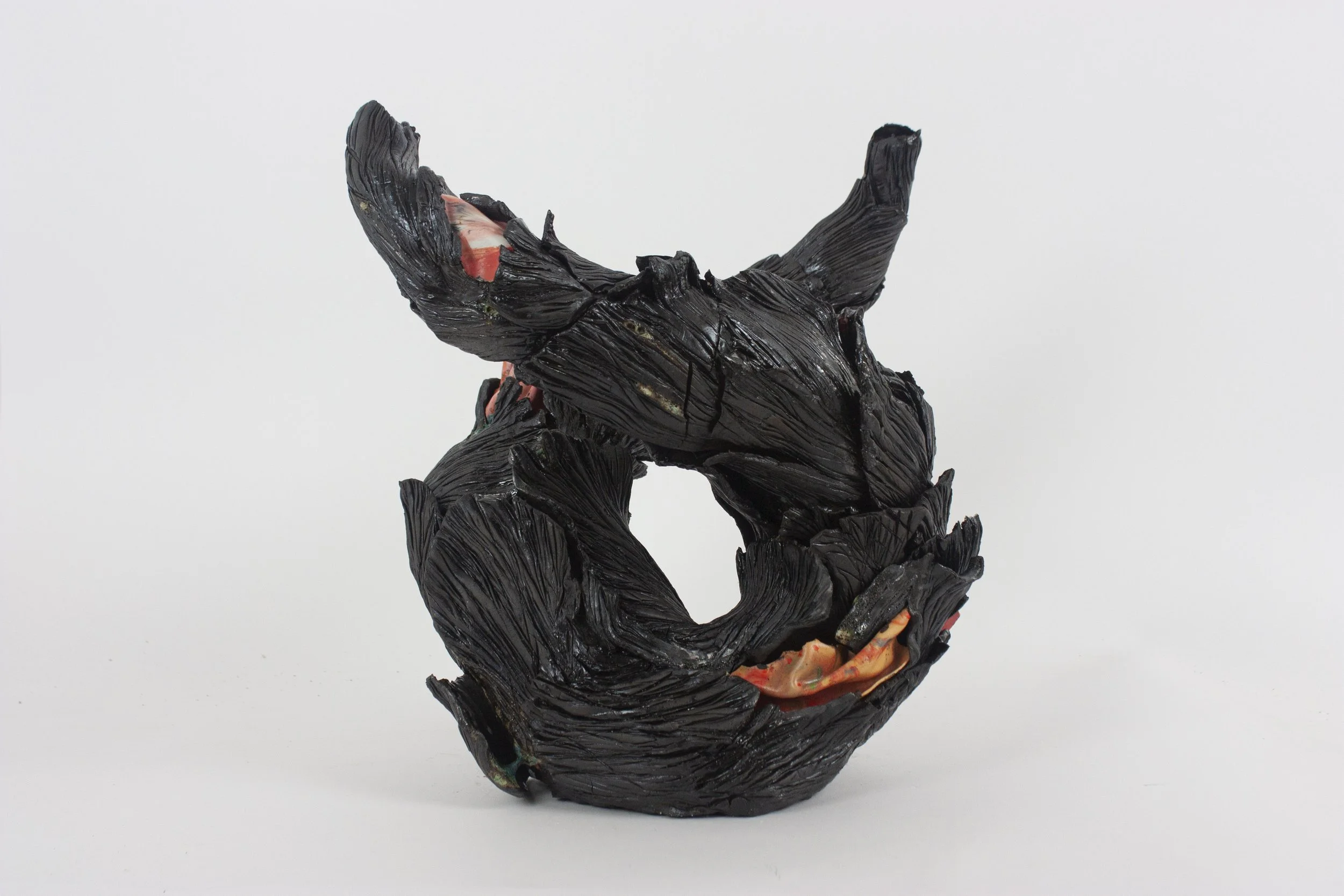 "Away from center," 2024. Black stoneware, porcelain shards, glaze. 19 x 13 x 11 inches.