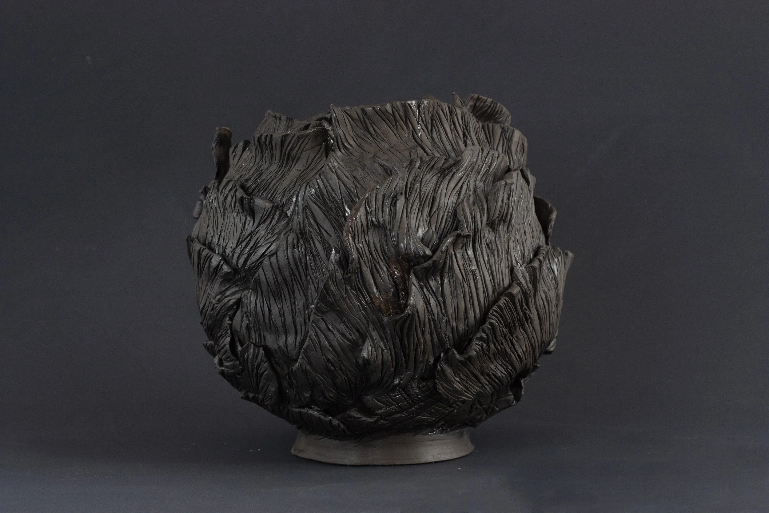 "Magnolia Jar 1" 2024. Black clay, glazes. 10 x 10 x 10 inches.