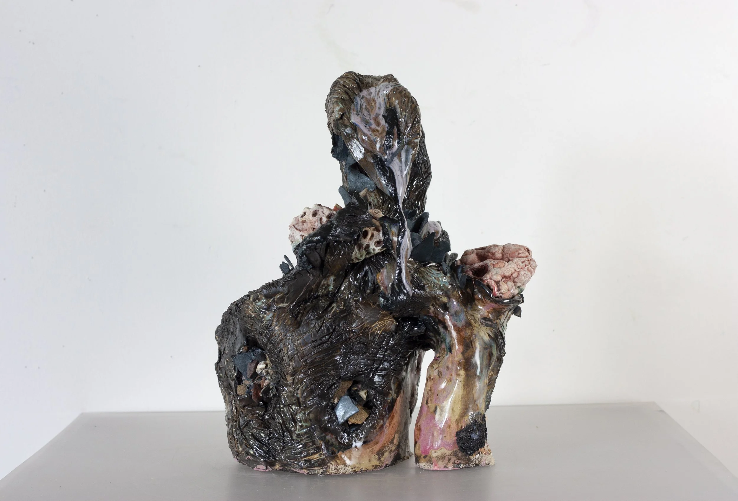 "Scorpion Mother," 2023. Serrated black stoneware, underglaze, crushed steel glaze, melted steel chips, Huzzah Valley found rocks, studio detritus, glaze.