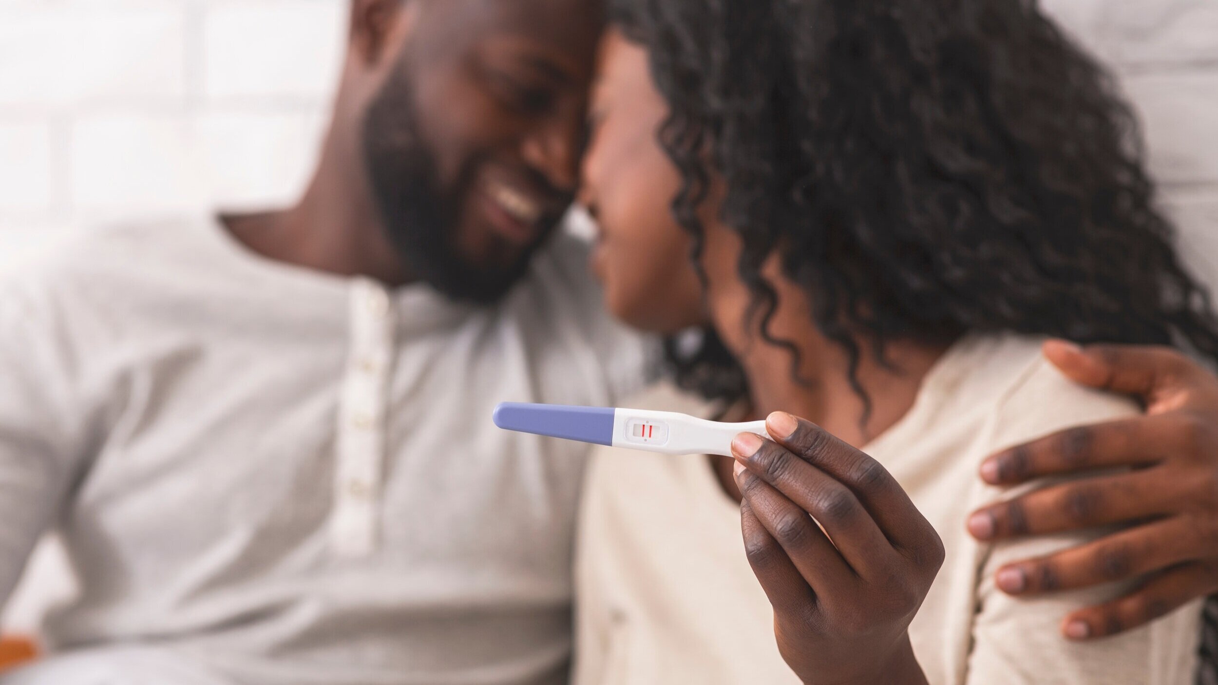  Photo of a happy woman and man with a positive pregnancy test. 
