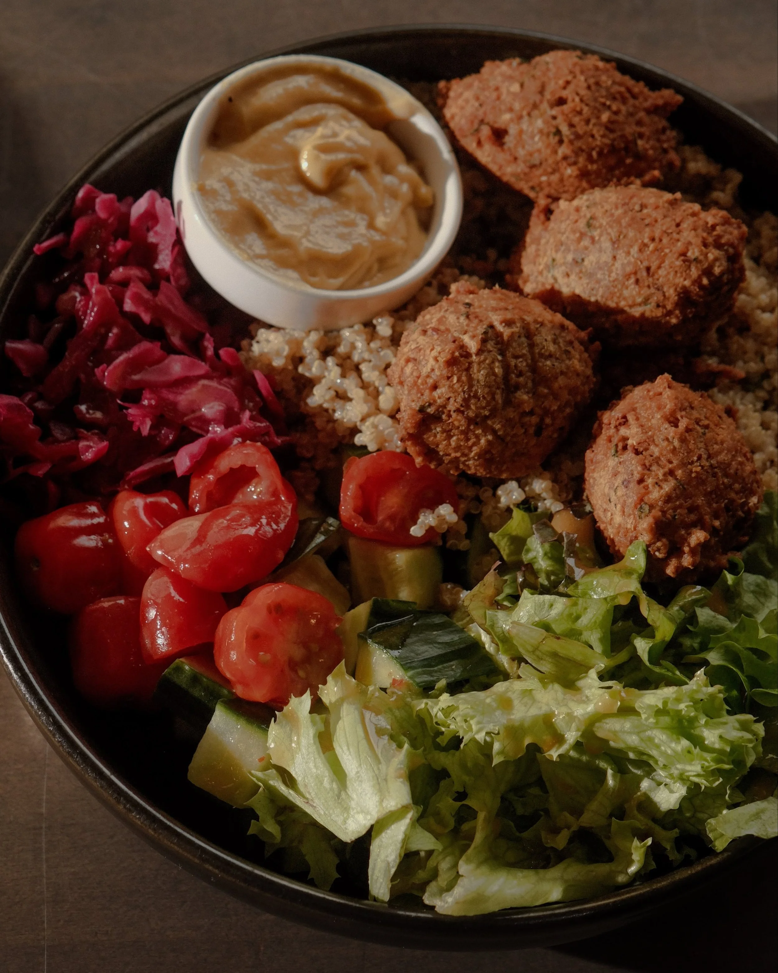 Open for LUNCH! Wednesday-Friday at 11:30am

Falafel Bowl $15
Greens, pickled cabbage, tomatoes, cucumbers, house dressing, quinoa tabbouleh, maple lemon tahini