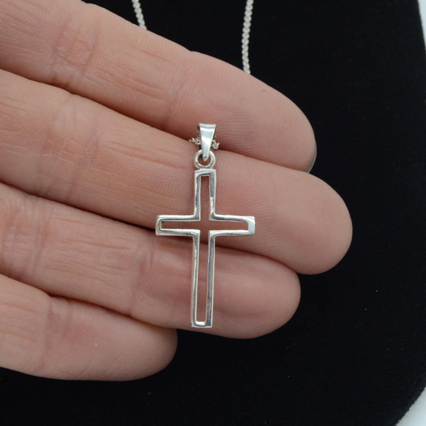 SS_red-mountain-cross-pendant-hand.jpg