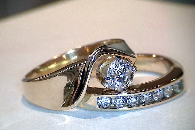 Round Cut Diamond Engagement Ring in solid 14K gold setting with channel set diamond accents