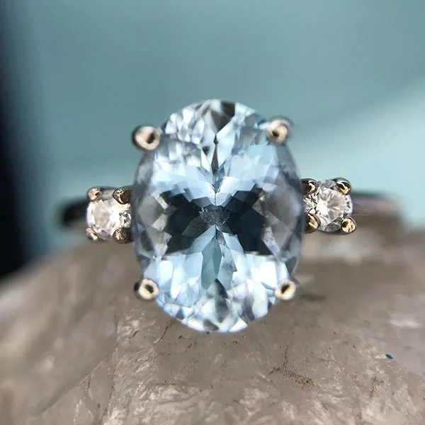 Icy blue Aquamarine faceted ring with diamond accents in 14K white gold
