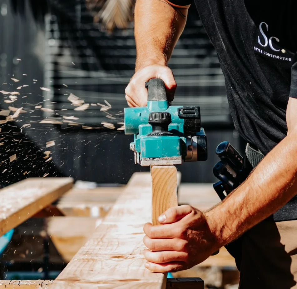 Style Construction builder working with a power tool