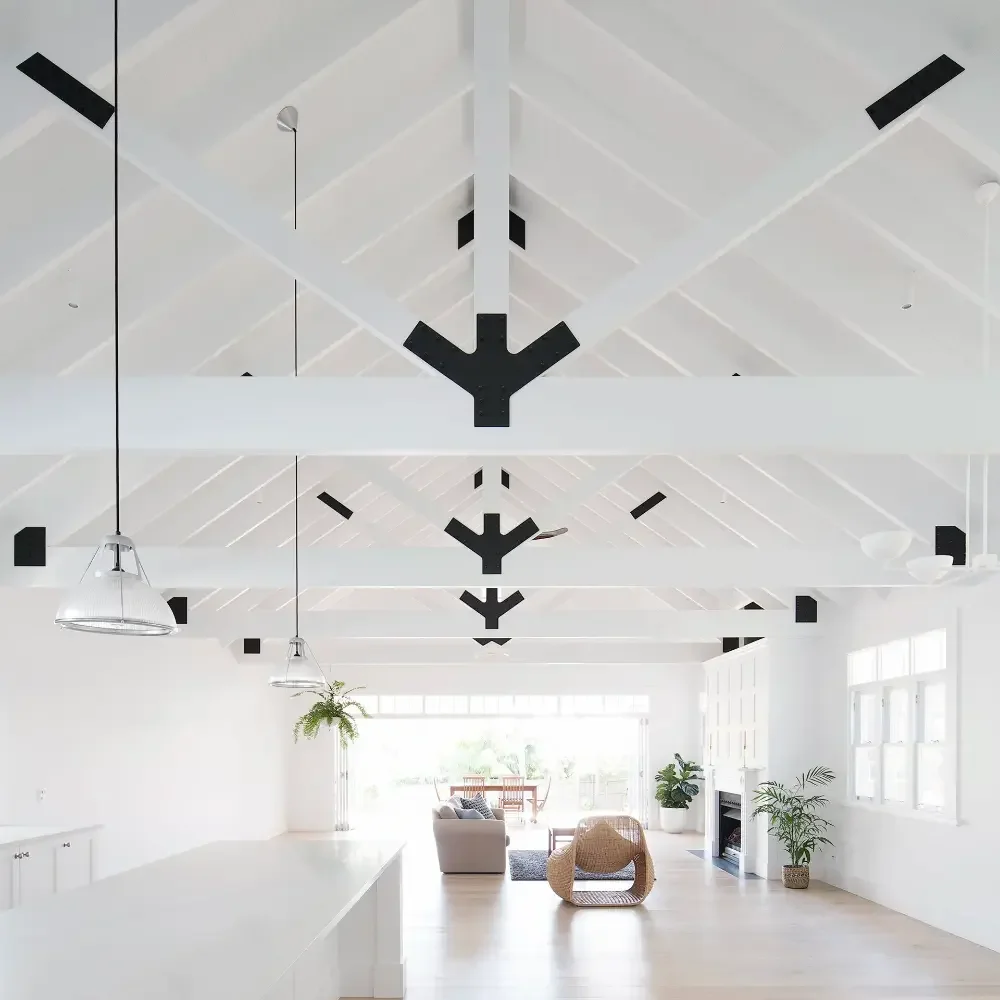The inside of a house with exposed trusses