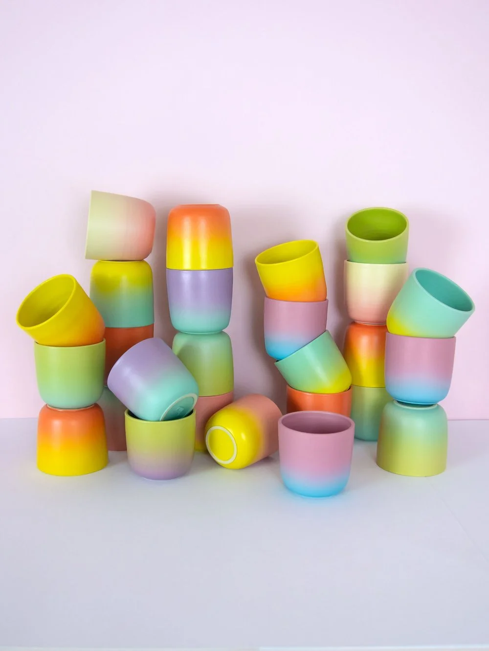 Colorful small handmade ceramic cups stacked haphazardly