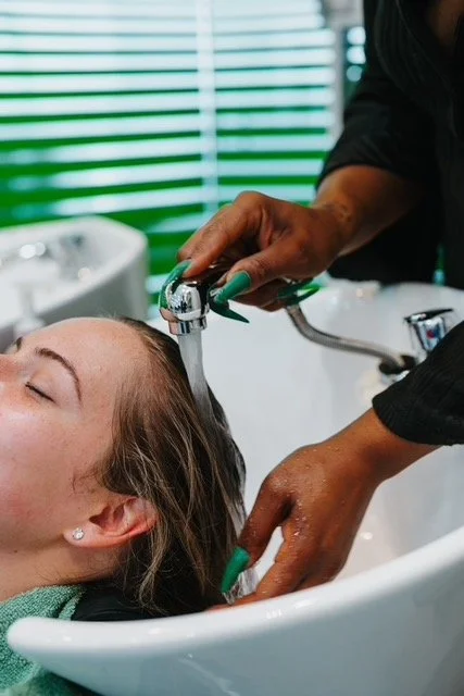 Client receiving a professional hair wash at a Boston hair salon