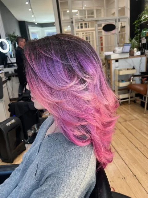 Pink and purple blended hair color styled at a Boston hair salon