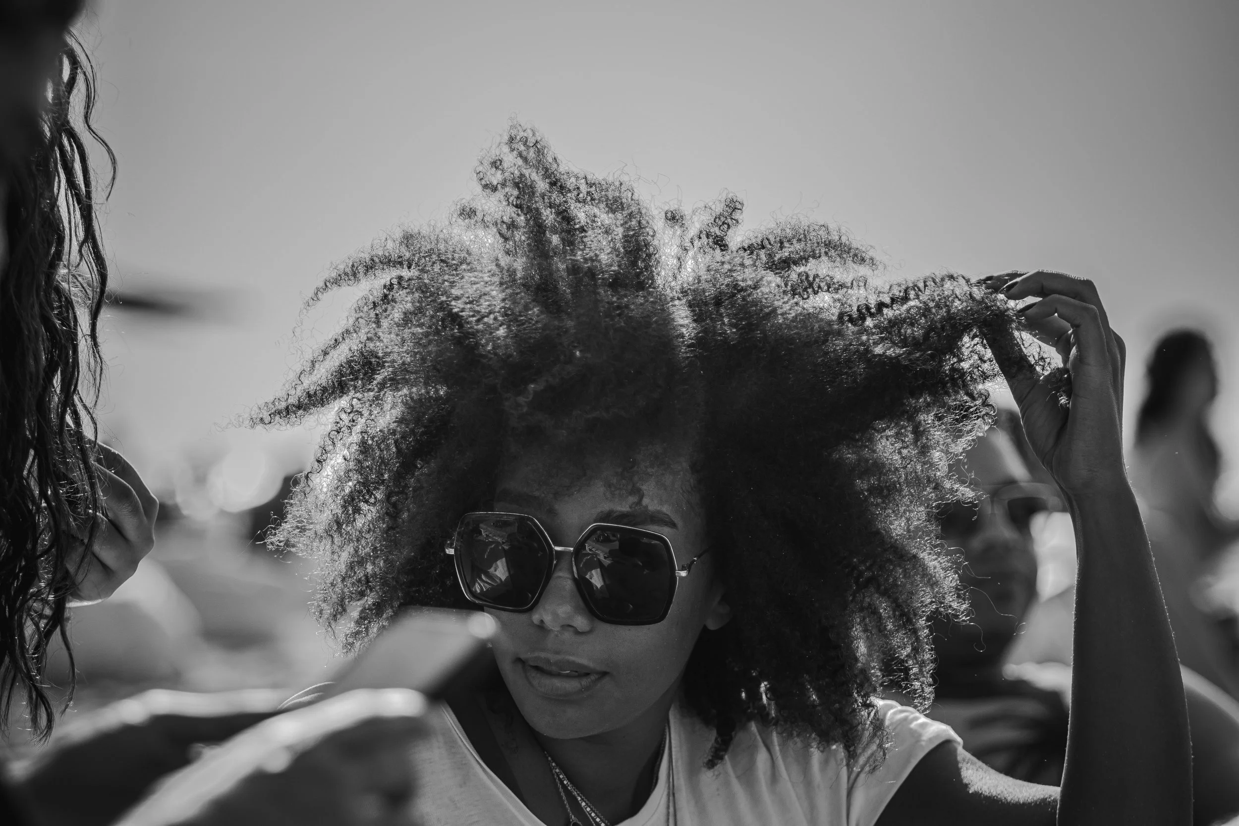 Dry, frizzy hair with visible flyaways and rough texture during fall weather in Boston.