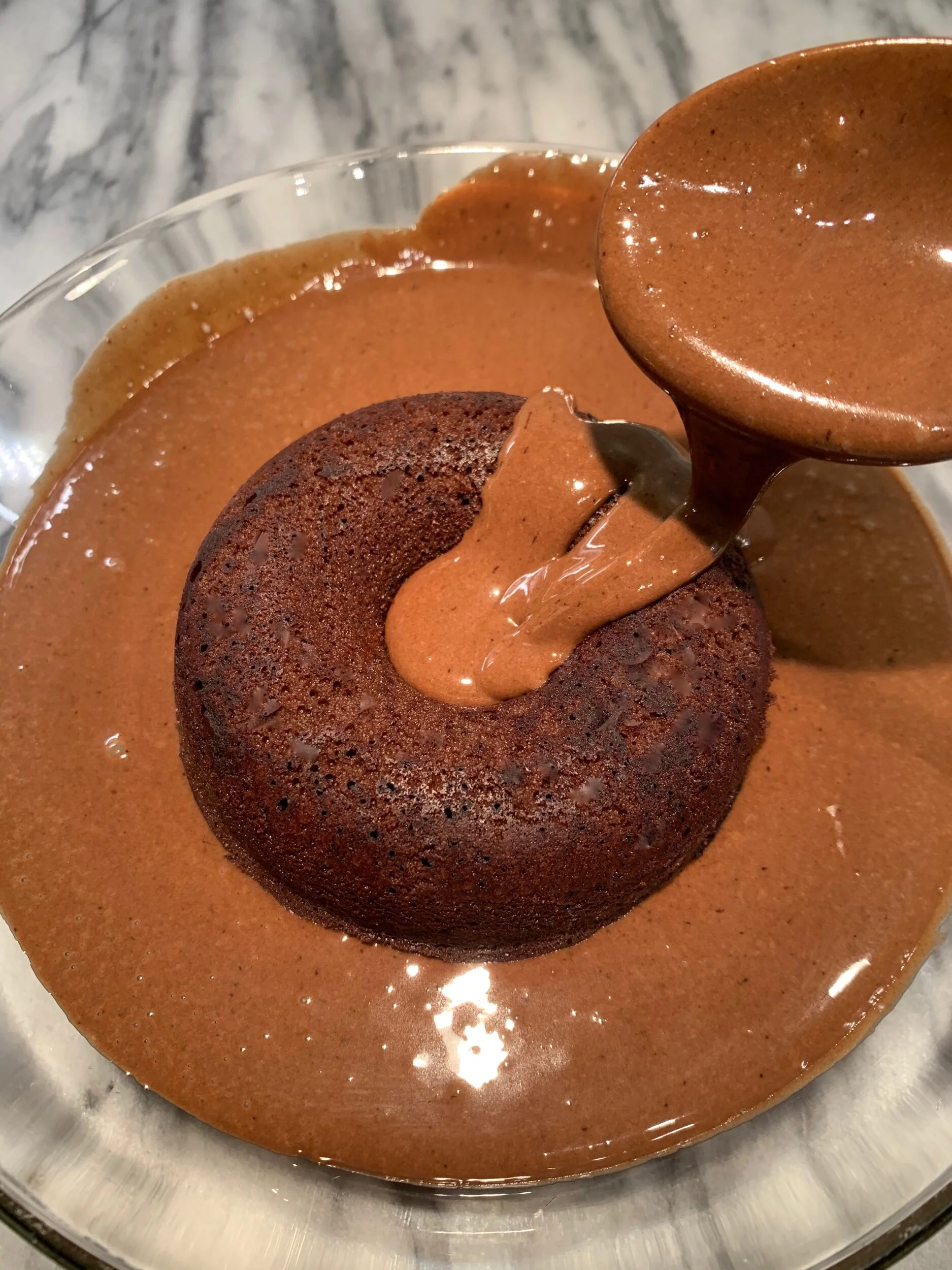 Coat the doughnut by first spooning glaze over top, then lifting out with two forks from underneath.