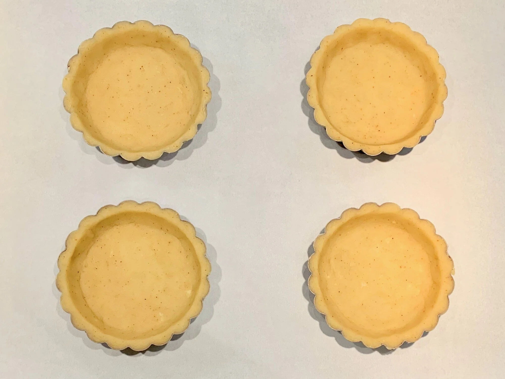 Lined tart pans. See those little flecks of chili in the dough? Yum!