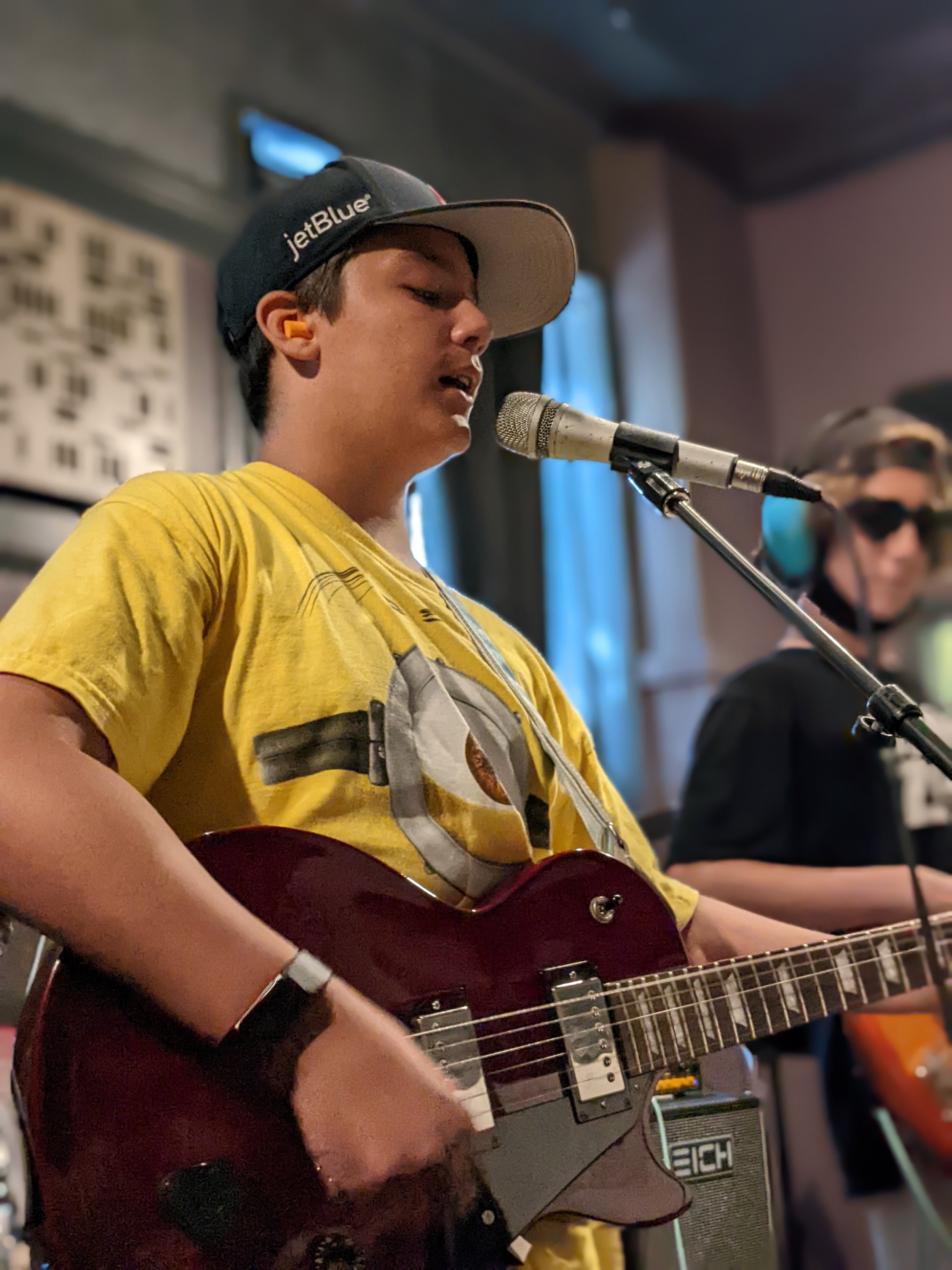 Teen singing and playing guitar.jpg