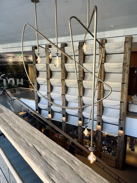 A light fixture hangs in front of a cloth backdrop in the 1 West Hollywood Hotel.