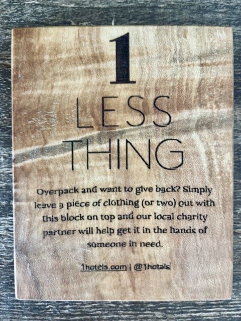 A sign at the 1 West Hollywood Hotel called 1 Less Thing prompt guests to leave any items they don't want to take back home to be donated to charity.
