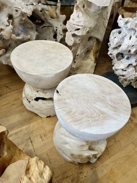 Teak root tables and other natural wood art pieces are displayed at DOA.