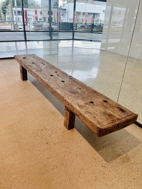 A wooden bench at the James Perse showroom.