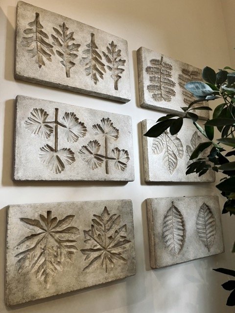 Imprinted leaves on stone are hung on a wall at the Formations showroom in West Hollywood.