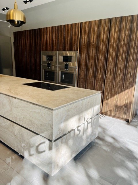 A modern kitchen island with cabinetry in the background at West Hollywood Design District.