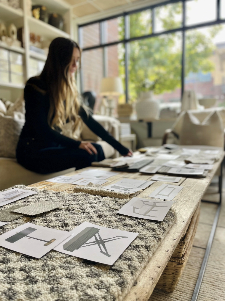 Anne Koepke, Technical Design lead looking over interior design plans