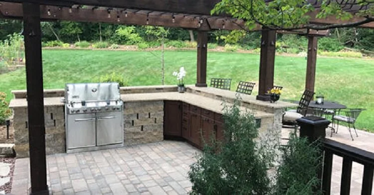 custom outdoor kitchen in Fitchburg, WI with built-in outdoor grill and organized outdoor cabinets.