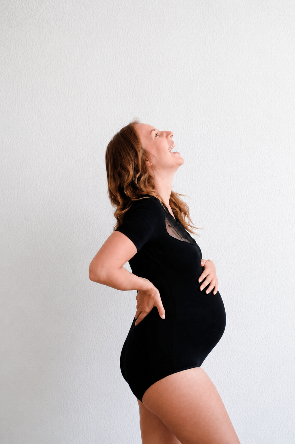 athletic pregnant woman laughing