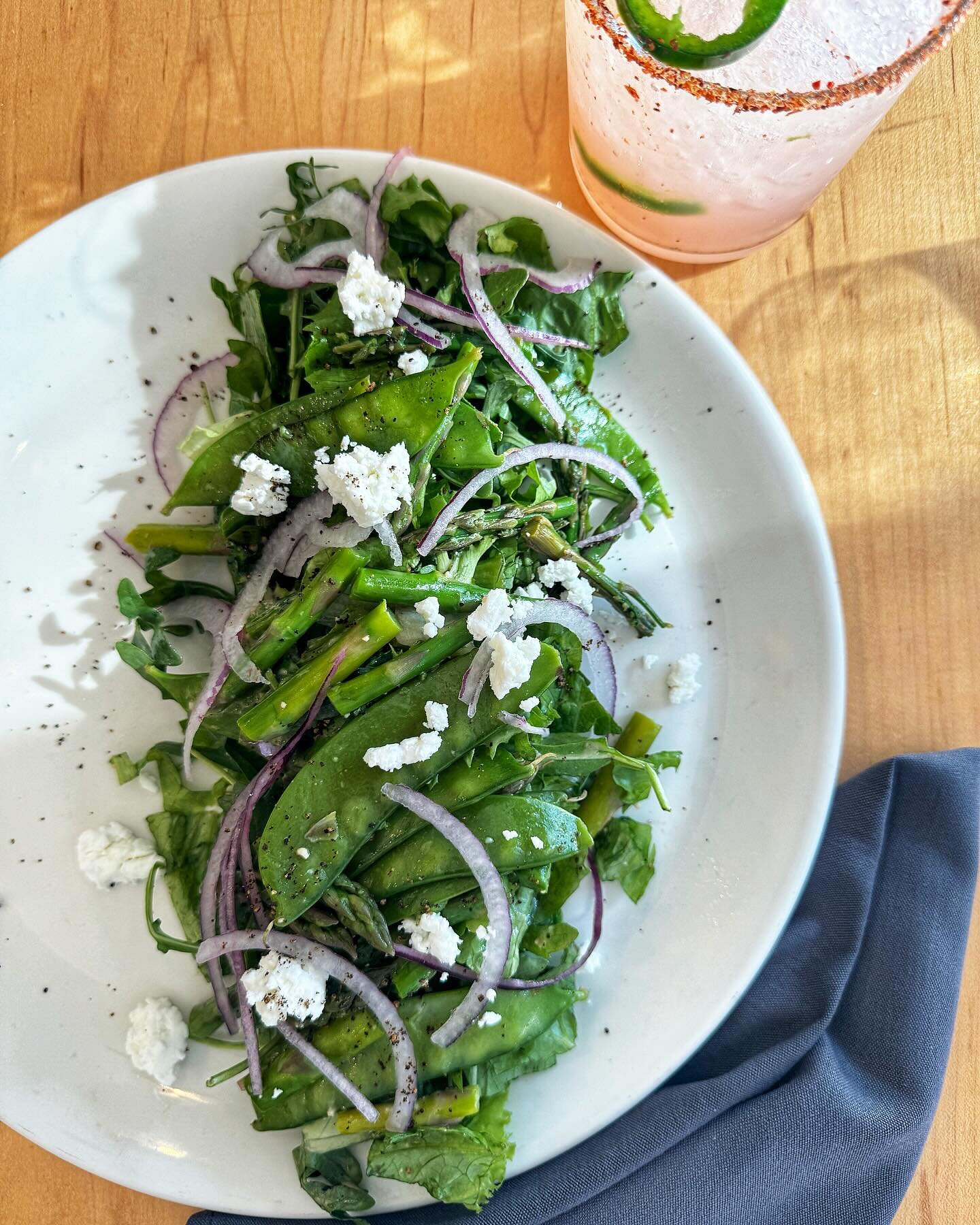 Our minds are on Spring! 🌷Asparagus Salad with Snow Peas, Goat Cheese, Red Wine Vinaigrette, Shaved Onion + Spicy Paloma