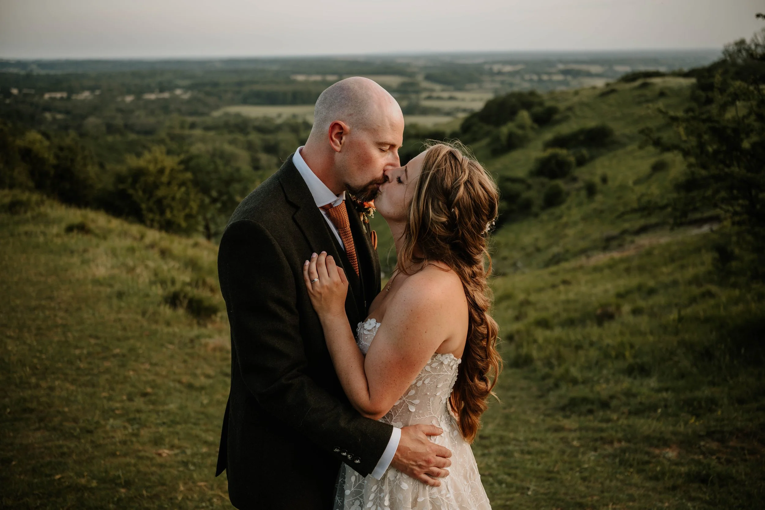 bride and groom kissing in front of the large valley opposite the Crown Lodge