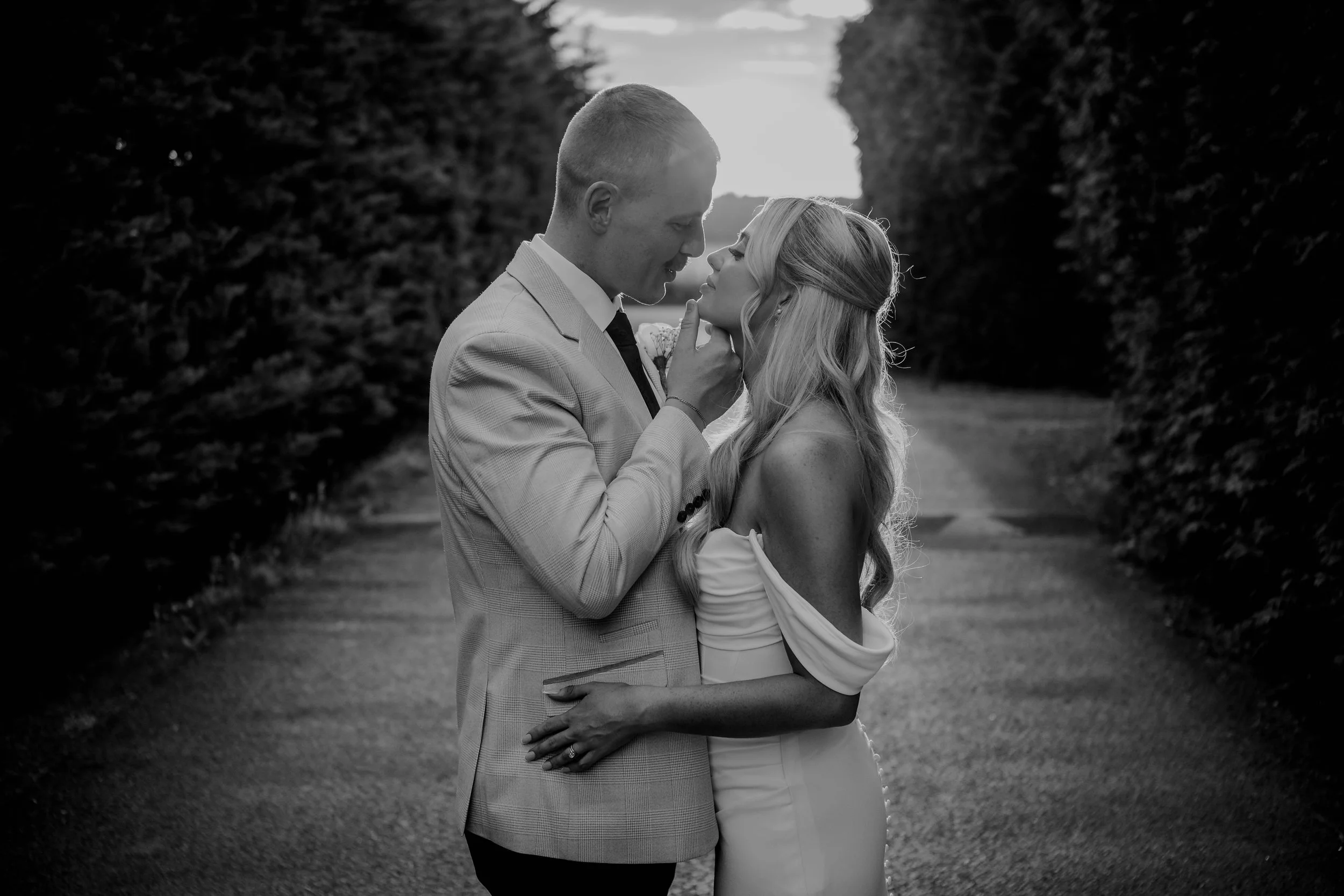 Bride and groom facing each other on the driveway at Old Kent Barn